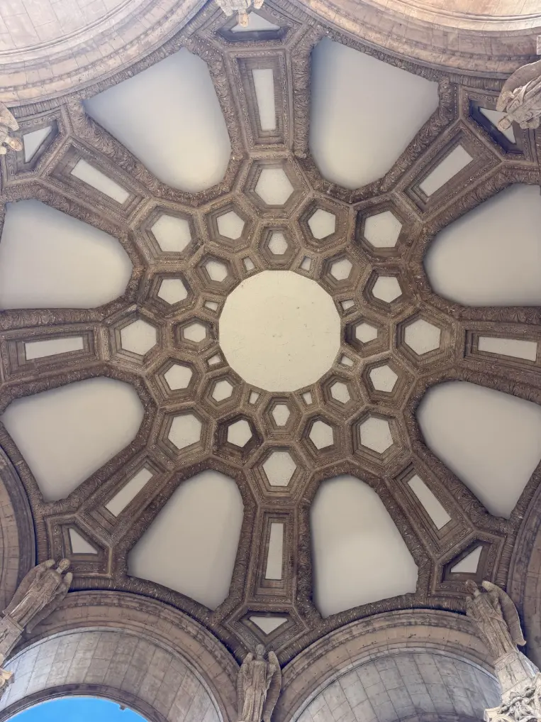 The ornate carved ceiling of an old structure.